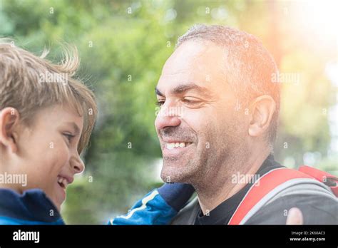 Happy father and son hugging and playing together in green nature Stock Photo - Alamy