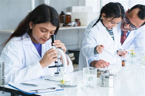 Indian scientist woman student using microscope do an experiment at ...