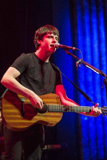 Photos of jake bugg playing his guitar in concert