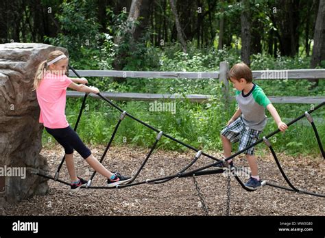 kids playing on rope bridge Stock Photo - Alamy