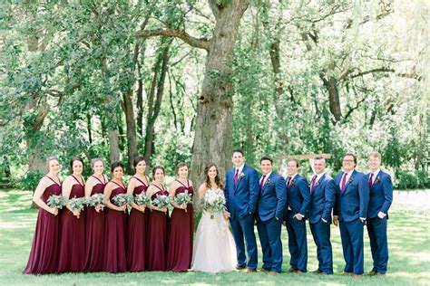 bridal party pose ideas | burgundy and blush bridesmaids dresses | groomsmen in navy suits ...