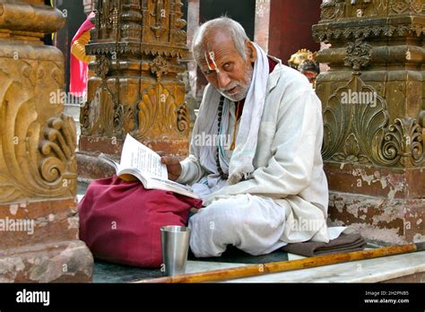 INDIA. BENARES. PANDIT (HINDU PRIEST) READING THE SCRIPTURES IN THE FAMOUS DURGA TEMPLE IN ...