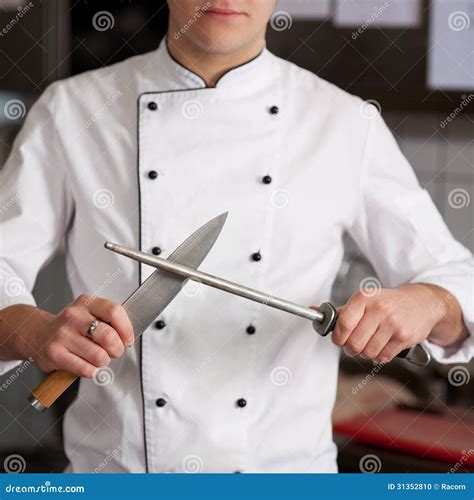 Chef Sharpening Knife in Kitchen Stock Photo - Image of chef, focus: 31352810