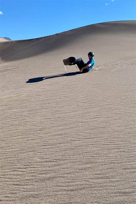 Sandboarding in Colorado (Great Sand Dunes) - Champagne Tastes®