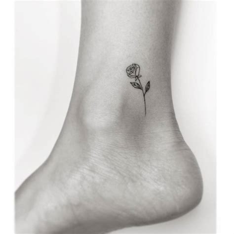 Fine line rose tattoo on the ankle.