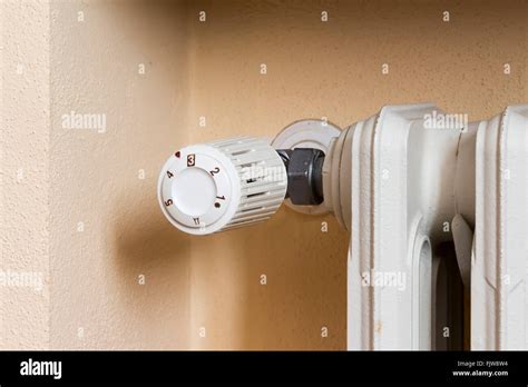 Close up photo thermostatic valve installed on radiator Stock Photo - Alamy