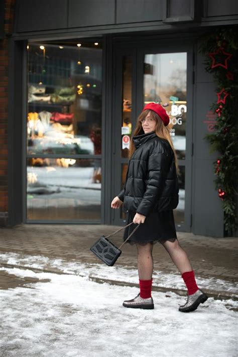 Woman Walking on a Sidewalk in Winter · Free Stock Photo