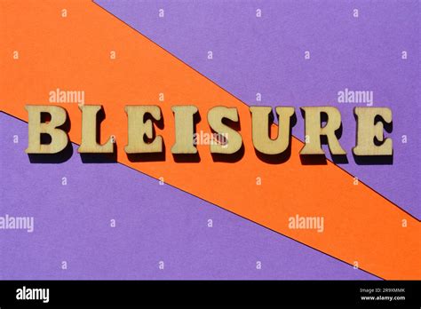 Bleisure, word in wooden alphabet letters isolated on colourful background. Buzzword created by ...