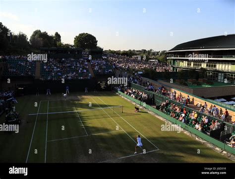 Caroline Garcia and Ana Bogdan (top) on day three of the Wimbledon Championships at The All ...