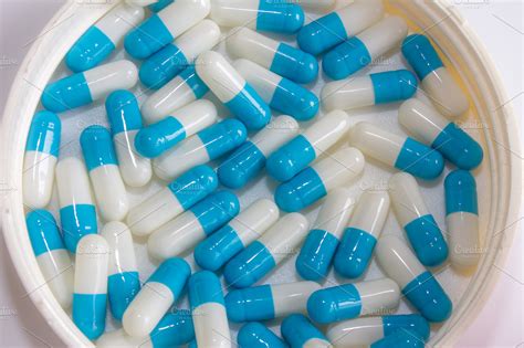 Blue white capsule drug isolated ~ Health Photos ~ Creative Market