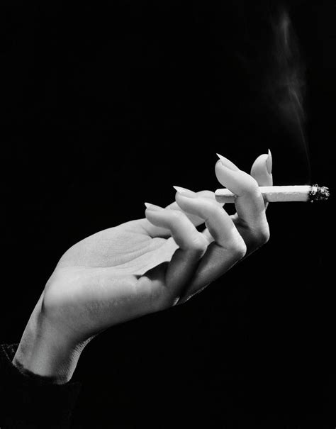 Womans Hand Holding Lit Cigarette by George Marks