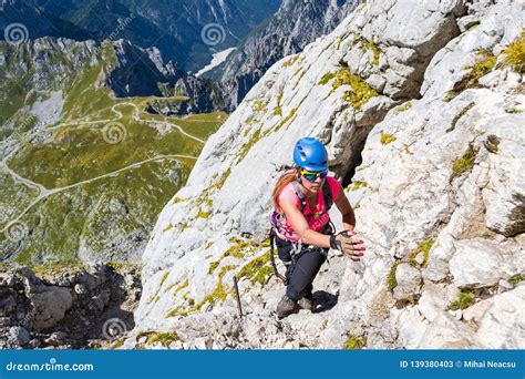 Woman Hiker Scrambling on a Route in Mangart Mangrt Mountain, Just ...