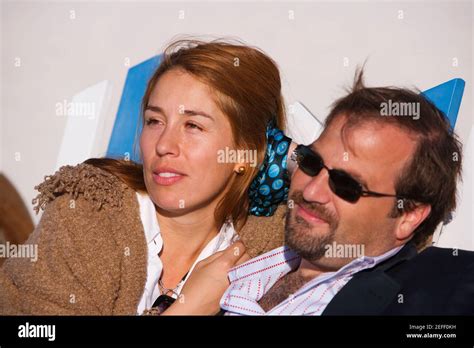 Close-up of a mid adult couple reclining on a lounge chair Stock Photo - Alamy