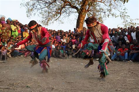 Traditional Nyau dancers with face masks at a Gule Wamkulu ceremony ...