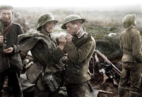 A German and British soldier share a cigarette during the Christmas Truce of 1914. : r/pics