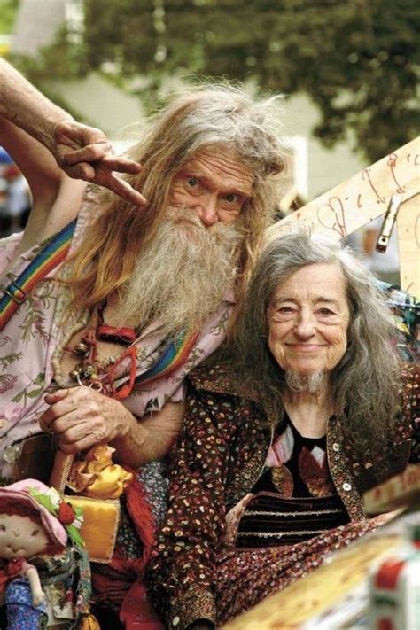 an old woman sitting next to a man with long hair