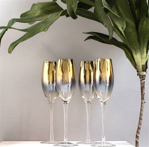 set of four gold dipped champagne flute by the forest & co | notonthehighstreet.com