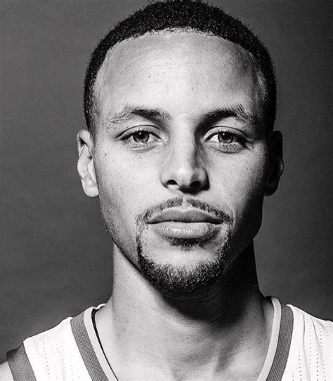 a black and white photo of a man with a basketball jersey on, looking ...