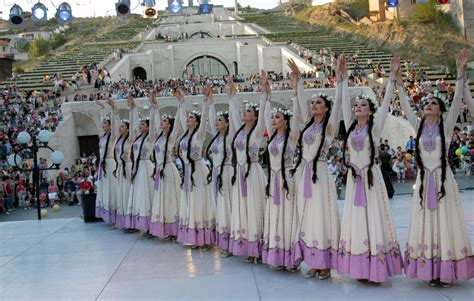 Armenian dancers performing at an outdoor concert at the Cascade monument in Yerevan, Armenia ...