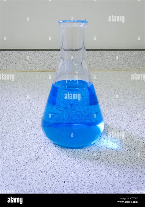 Blue copper sulfate solution in a conical flask on a laboratory bench Stock Photo - Alamy