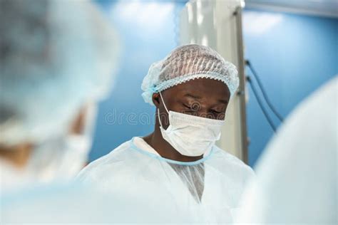 Portrait of a Doctor during Surgery in a Uniform and Medical Mask Stock ...