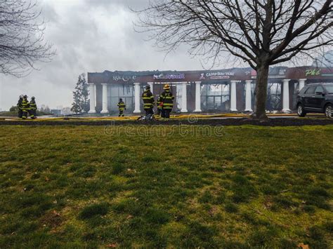 Firemen Survey the Damage To a Fire Scene that Destroyed Stores in a ...