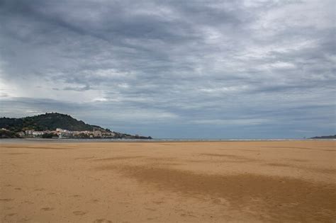 Premium Photo | Castro urdiales beach in a day with grey clouds.