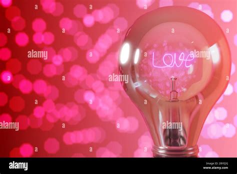 3D rendering background , Close up view, wording " love " glowing light bulb with warm ...