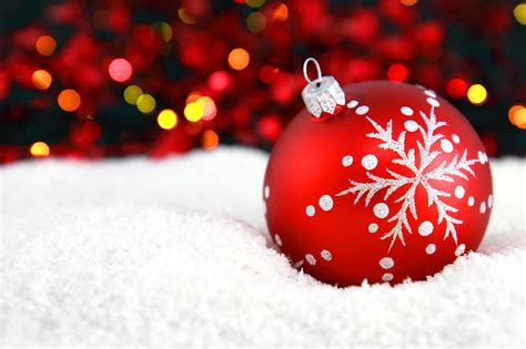 Christmas Ornament | Free Stock Photo | A red Christmas ornament in the snow with lights in the ...