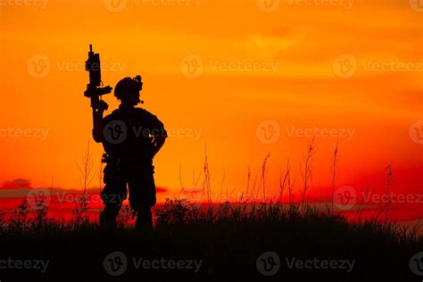 Silhouette of military soldier or officer with weapons at sunset ...