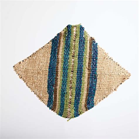 a piece of woven material hanging from the ceiling with blue, green and ...