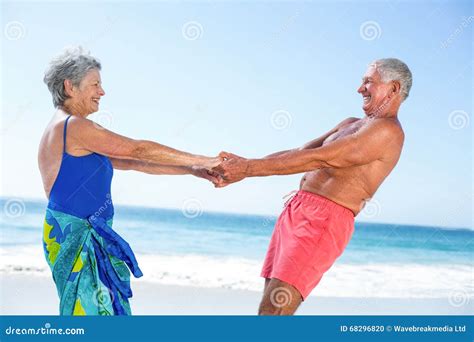 Cute Mature Couple Holding Hands on the Beach Stock Photo - Image of ...