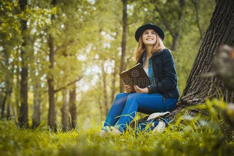 Relaxed Girl Reading an Book Under a Tree Stock Photo - Image of copy, country: 71448204