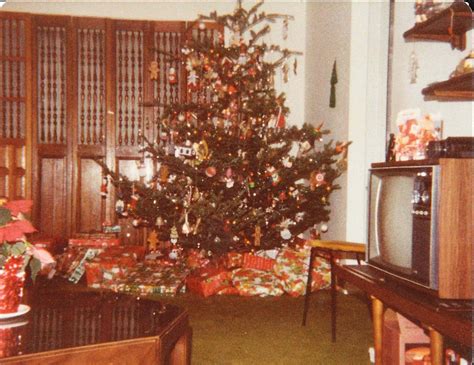 a living room with a christmas tree in the corner and presents on the ...