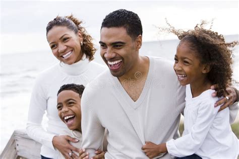 Happy African-American Family of Four on Beach Stock Photo - Image of affectionate, sand: 12825312