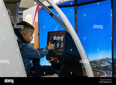 Boy and helicopter flight training simulator, hands on education Stock Photo - Alamy