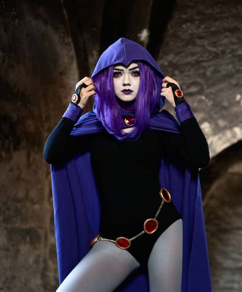 a woman with purple hair wearing a costume