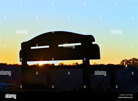 sunset through park bench Stock Photo - Alamy