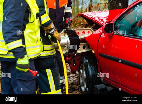 accident - fire rescue accident victims from car Stock Photo - Alamy