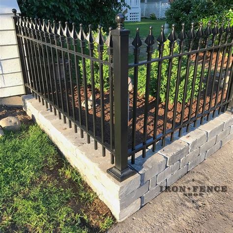 Our Stronghold Iron Fence in the Signature Grade on top of a knee wall. Great looking install by ...