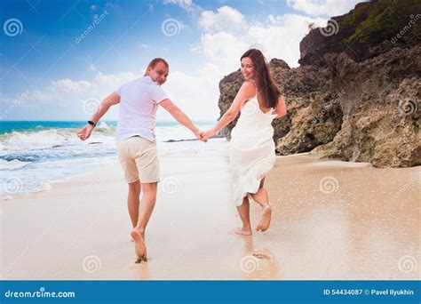 Happy Happy People Dressed in White Running at Beach Stock Image - Image of happy, blue: 54434087