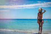 Young caucasian girl in black bikini on a beach | People Images ~ Creative Market