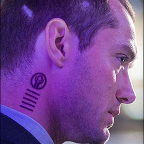 a close up of a person with a tattoo on their neck and behind his ear