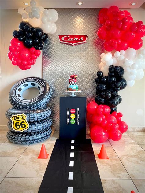 a car themed birthday party with balloons and race track decorations for the entrance to the room