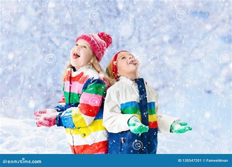 Kids Playing in Snow. Children Play in Winter. Stock Image - Image of ...