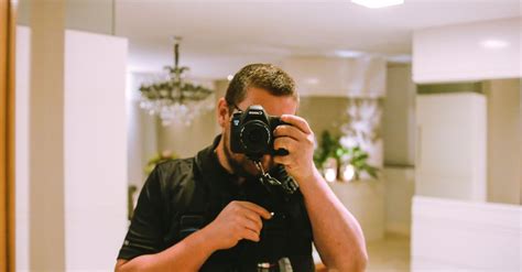 Man Using Black Dslr Camera · Free Stock Photo