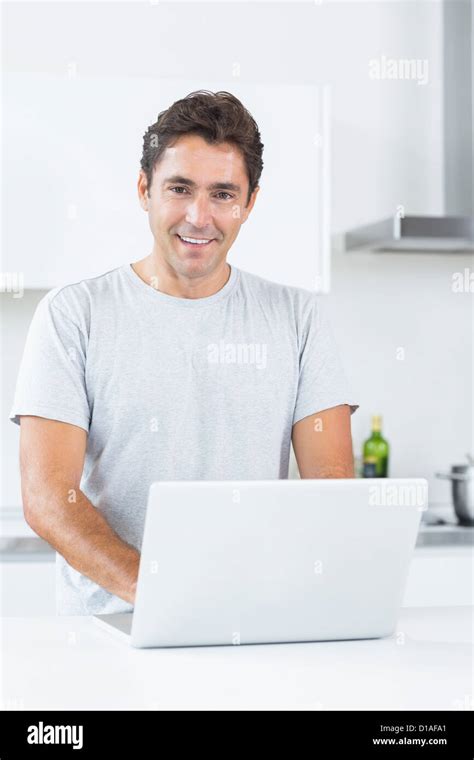 Smiling man with laptop Stock Photo - Alamy