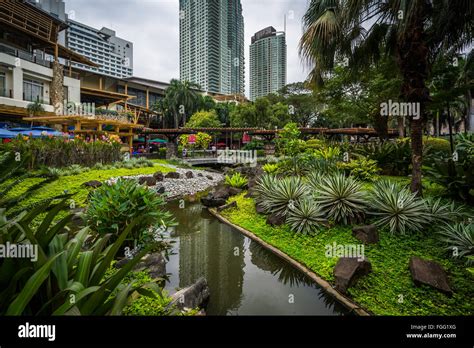 Gardens and skyscrapers at Greenbelt Park, in Ayala, Makati, Metro Manila, The Philippines Stock ...