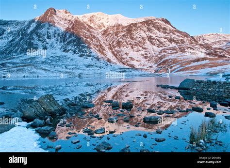 First Light on Y Garn above Llyn Idwal in Winter, Cwm Idwal, Snowdonia National Park, North ...