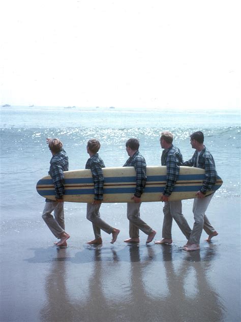 Beach Boys On The Beach With A Surfboard by Michael Ochs Archives